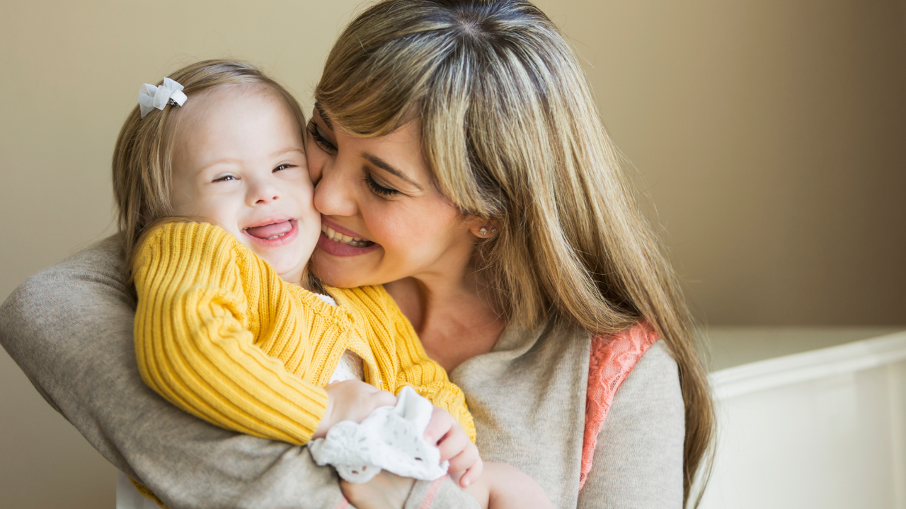A mother holding and caring for her child with intellectual and developmental disabilities — a representation of the families and individuals Empowered Services exists to serve