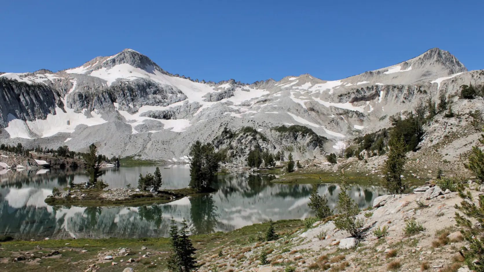 An alpine lake below the snow-streaked peaks of the Eagle Cap Wilderness, Wallowa County