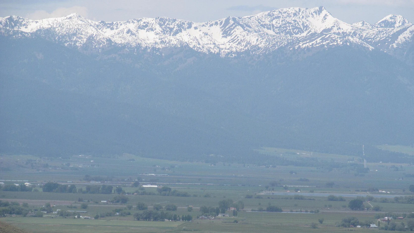 Snow-capped peaks of the Blue Mountains rising beyond the valley near Baker City
