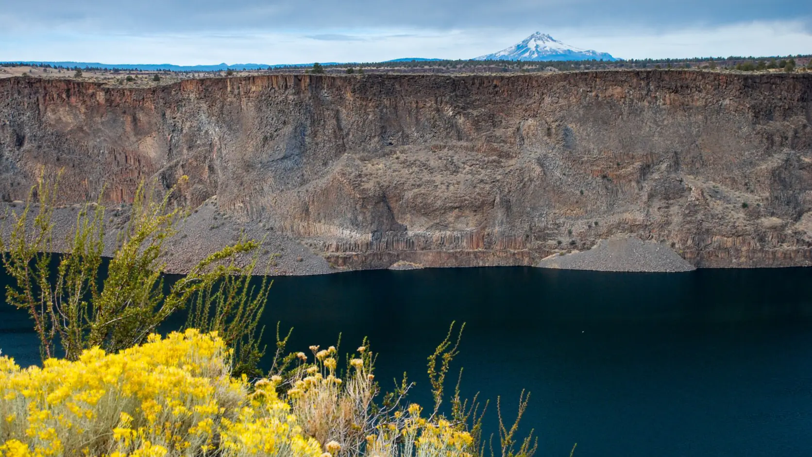 The canyon walls of Lake Billy Chinook at Cove Palisades State Park with Mount Jefferson beyond