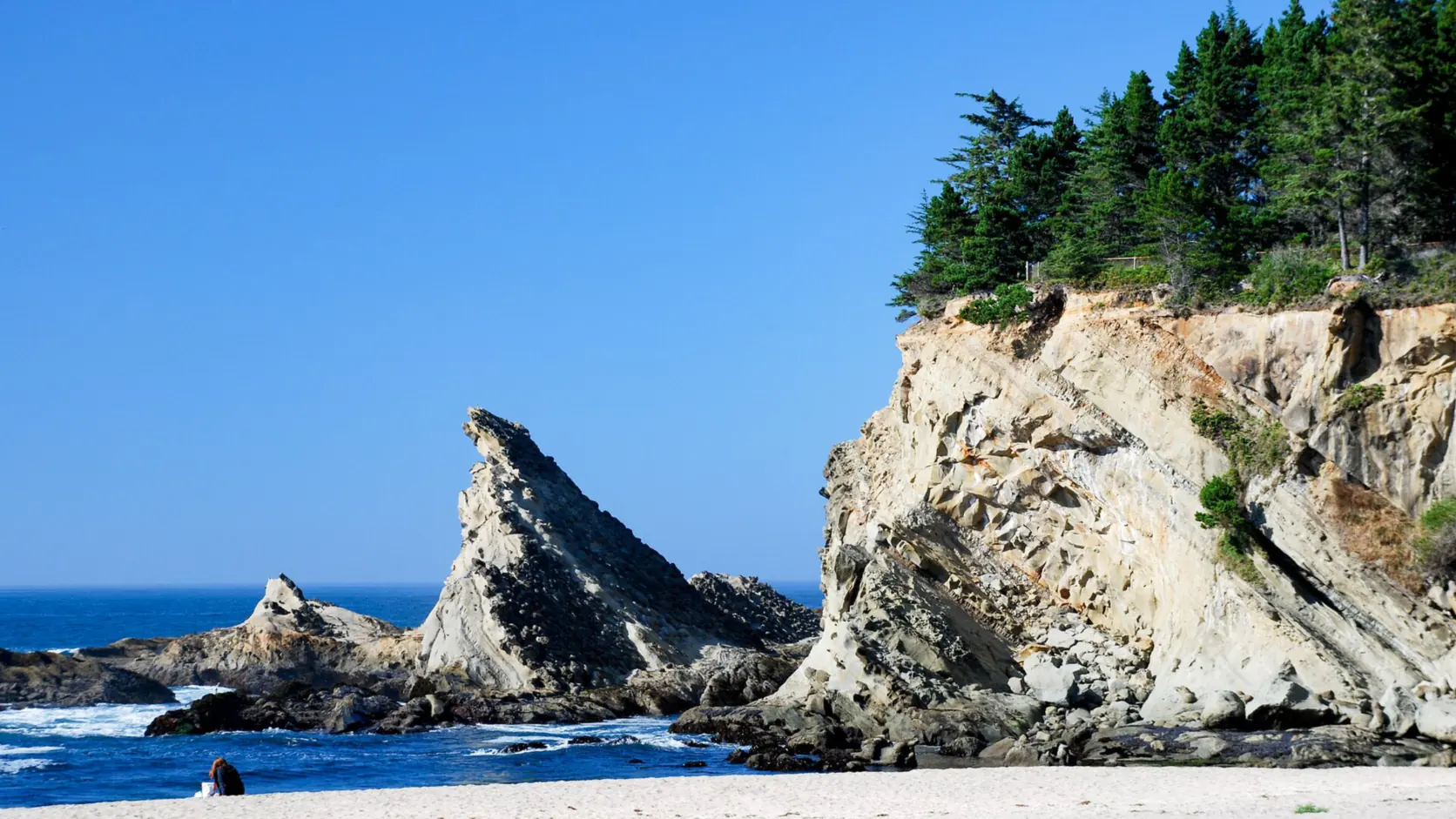Tilted sandstone cliffs and surf at Shore Acres State Park on the Coos County coast