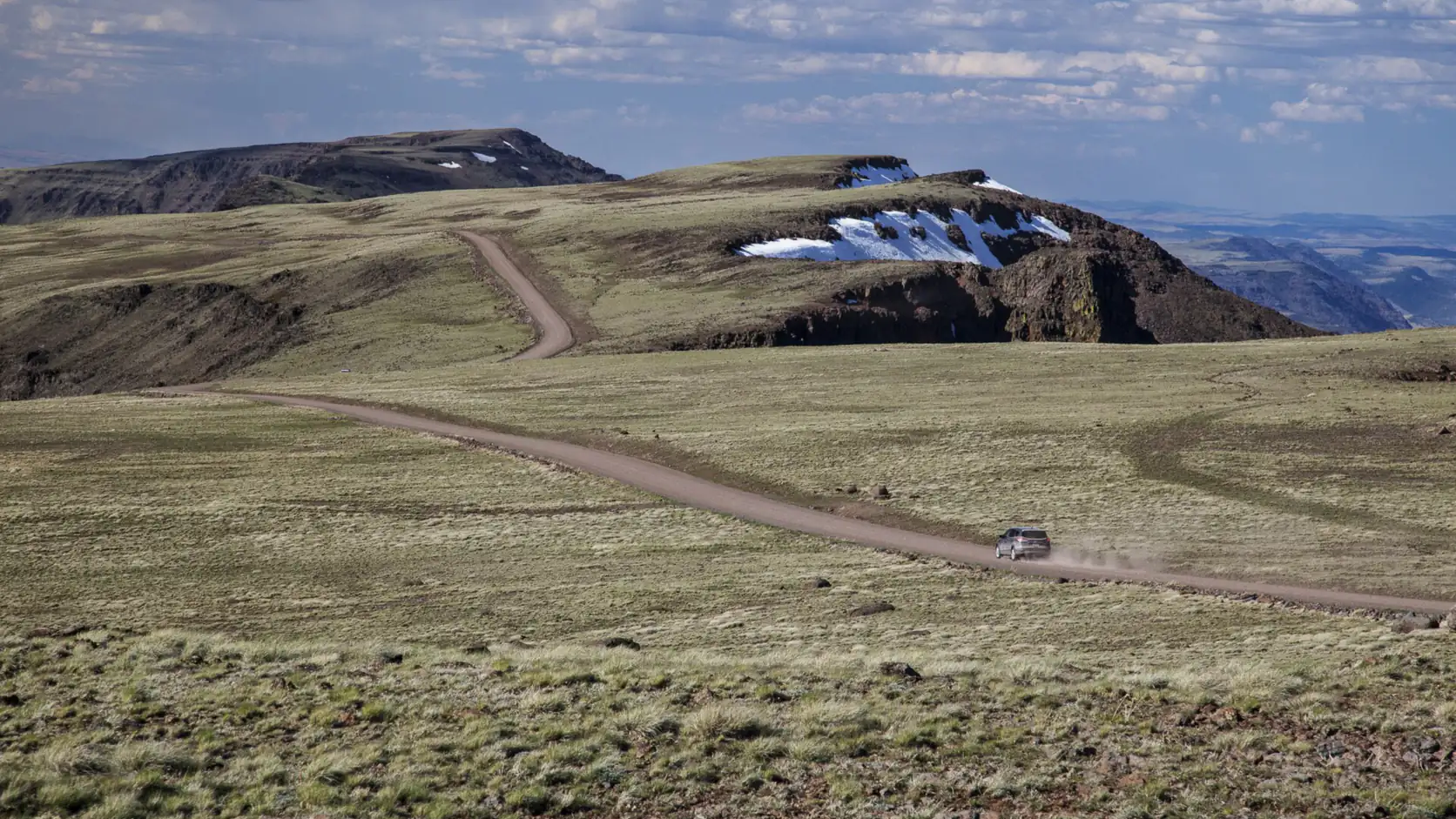 The long ridge of Steens Mountain above high desert grassland in Harney County