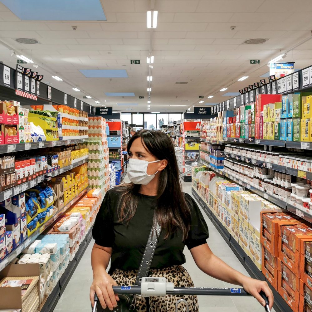 young-woman-wearing-face-mask-in-groceries-store-to-by-essentials-for-quarantine-during-covid_t20_yndyrx
